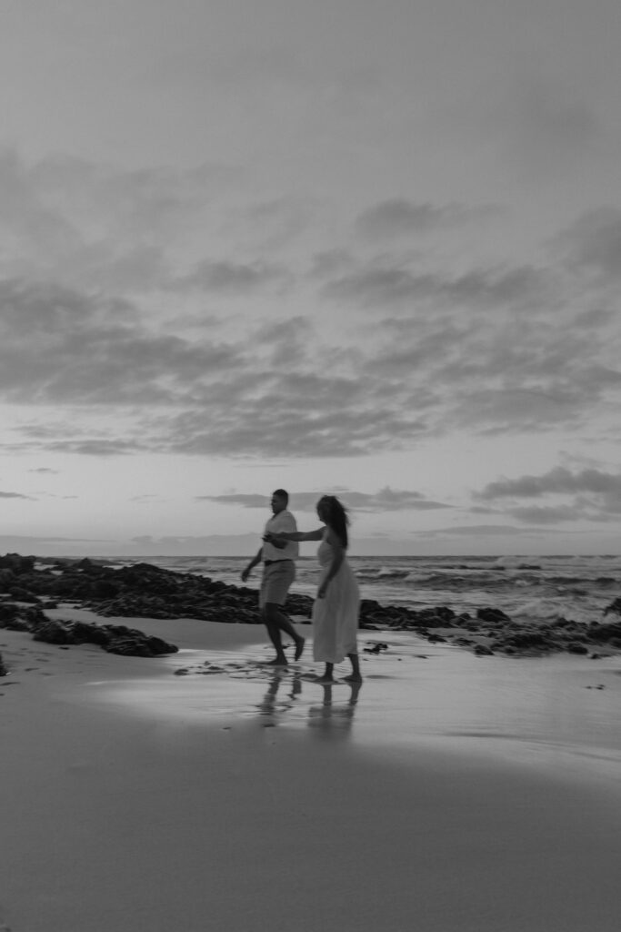 couple dancing between lava rock at Oahu Hawaii beach