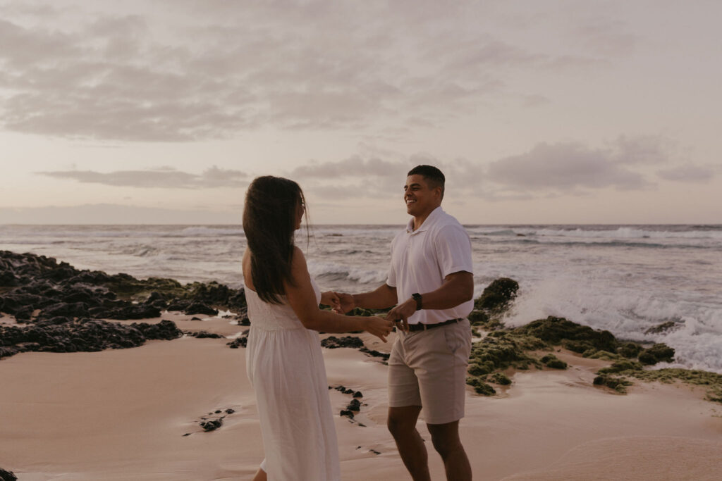 Couple dancing between lava rock at Oahu Hawaii beach