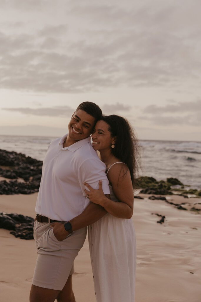 Couple laughing together at shoreline of Oahu, Hawaii Beach