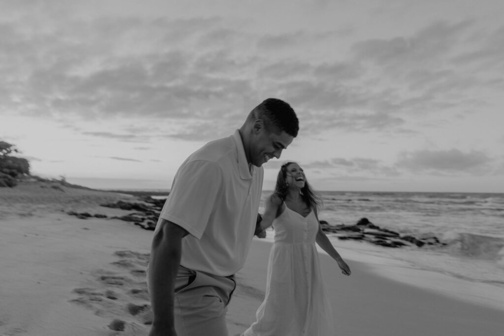 couple dancing between lava rock at Oahu Hawaii beach