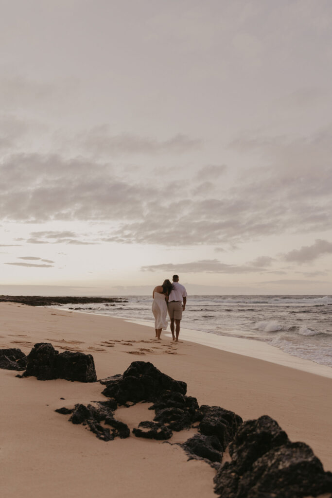 Couple walking towards the shore at Oahu Hawaii Beach