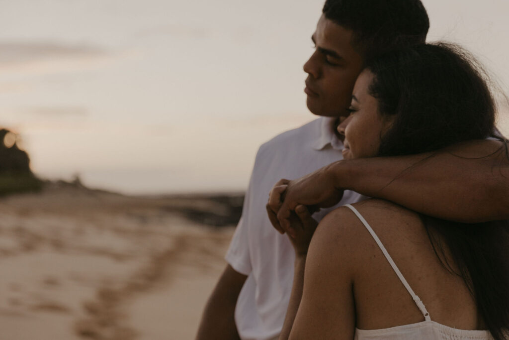 Close up of couple watching the sunrise in Oahu, Hawaii