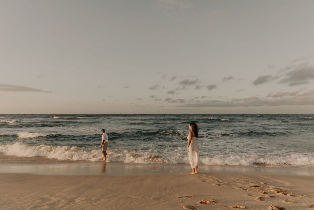 couple on the beach at sunrise in Oahu, Hawaii