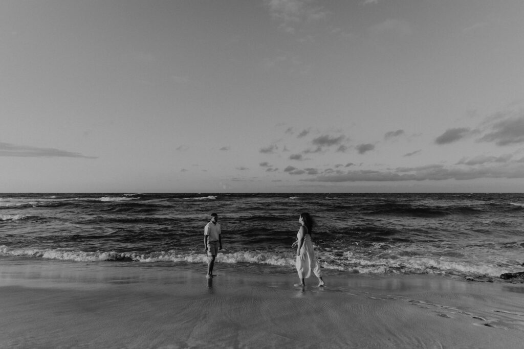 Black and white of couple on the beach at sunrise in Oahu, Hawaii
