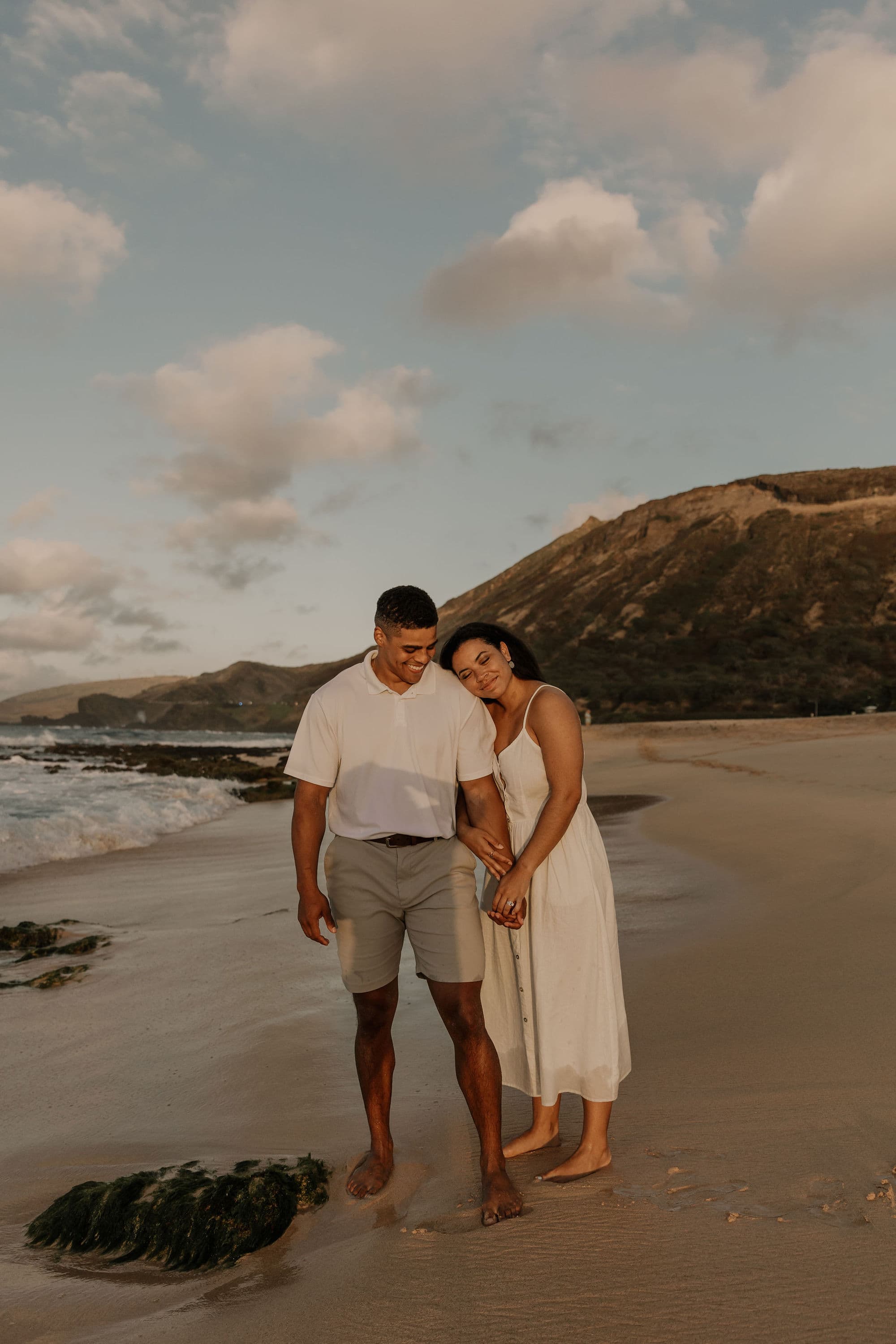 couple on the beach at sunrise in Oahu, Hawaii