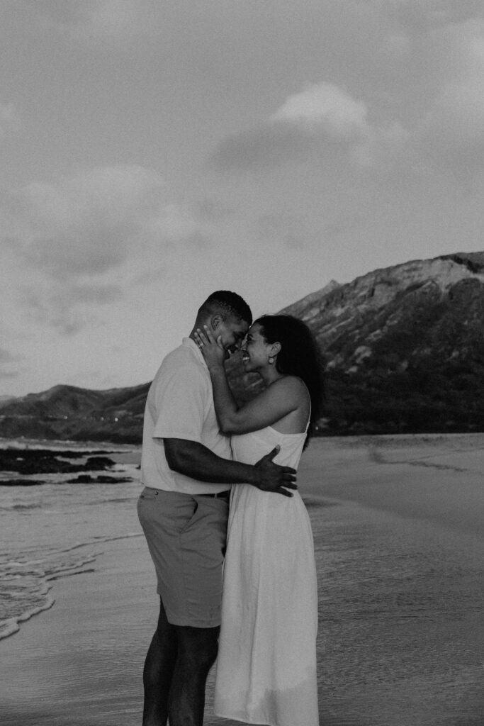 Black and white of couple kissing on the beach in Oahu, Hawaii