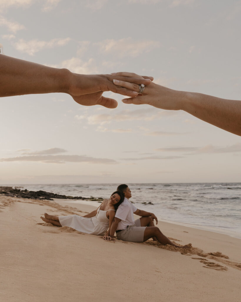 double exposure of couple sitting in the sand of a beach in Oahu, Hawaii