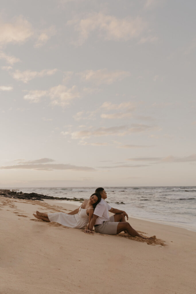 couple on the beach at sunrise in Oahu, Hawaii