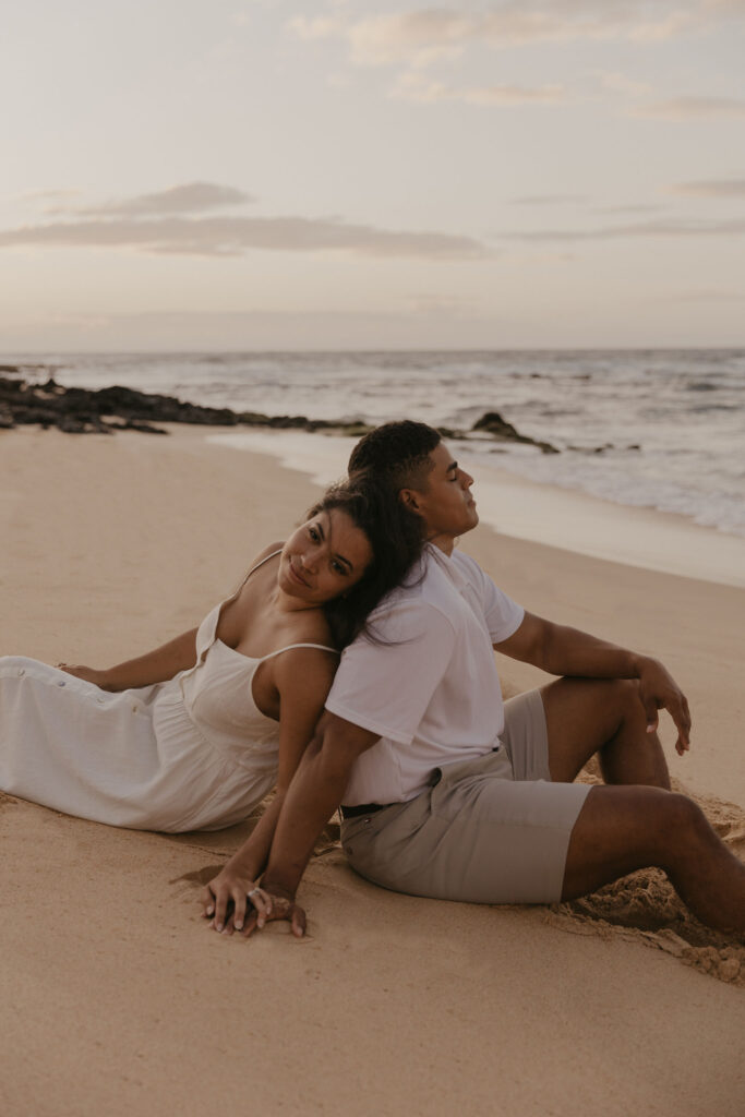 couple on the beach at sunrise in Oahu, Hawaii