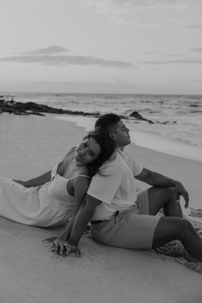 Black and white of couple on the beach at sunrise in Oahu, Hawaii