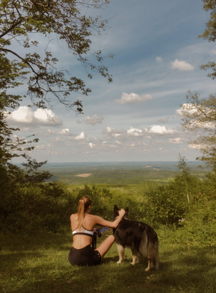 Girl hiking with dog looking out at the Virginia landscape