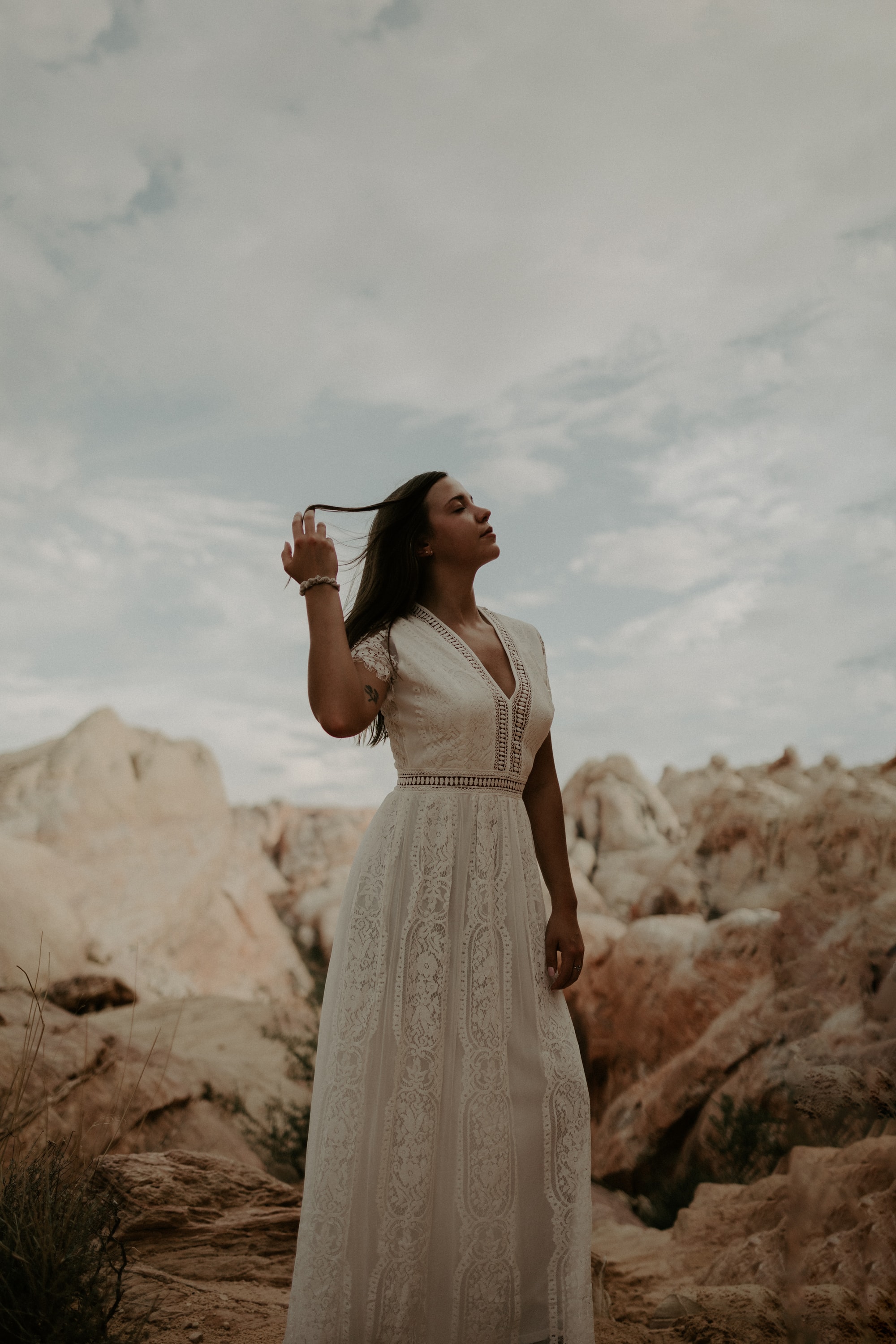 Bride hiking at sunset on her adventure elopement in Moab, UT