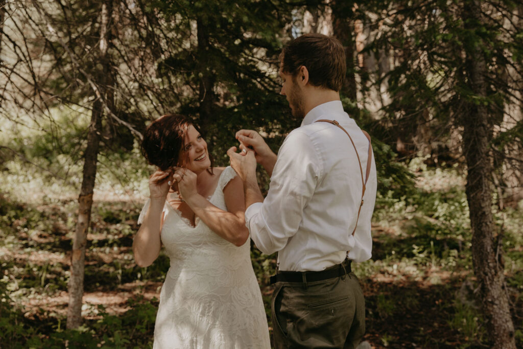 Couple getting ready in the woods for their elopement