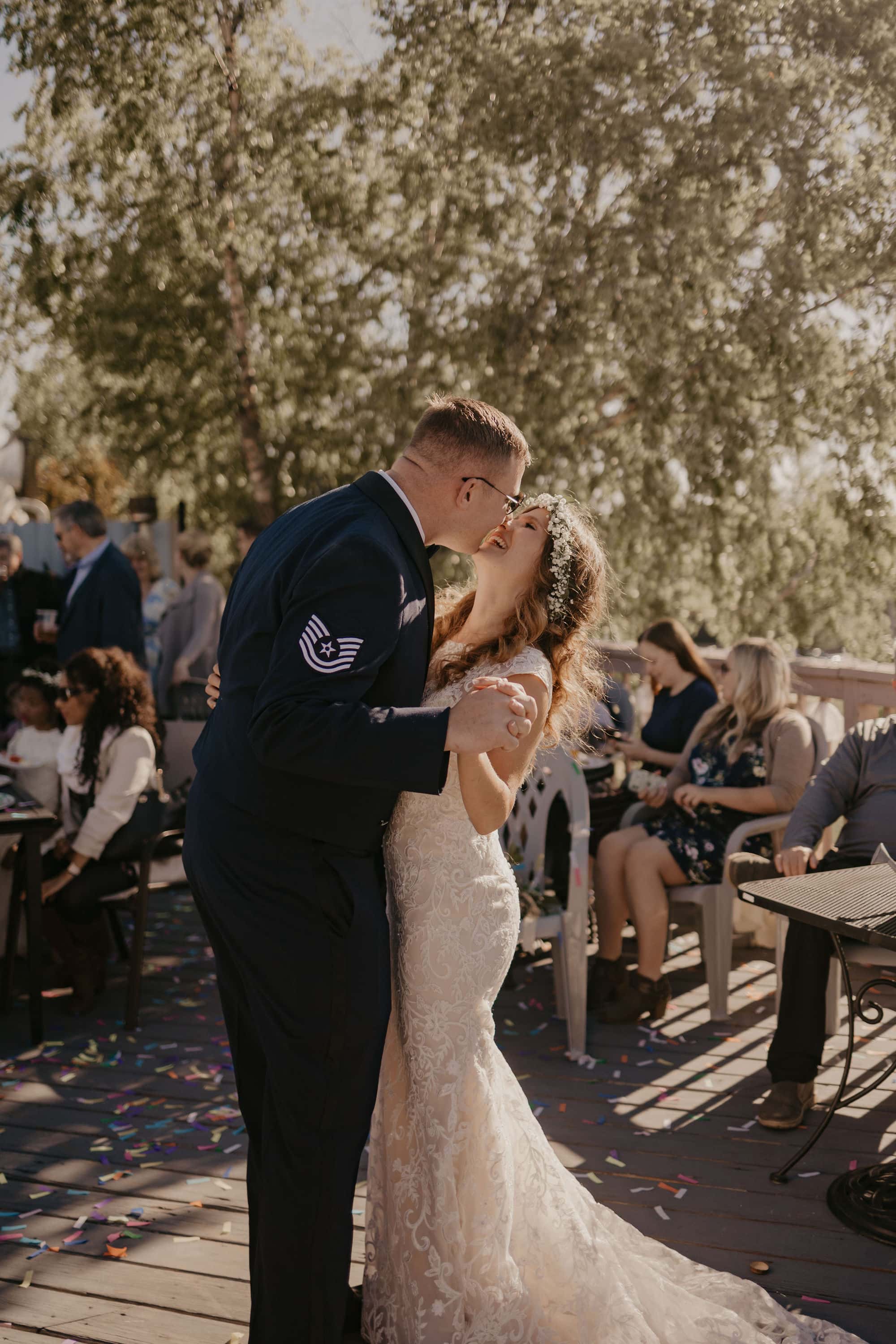 Military couple kissing in the middle of their first dance