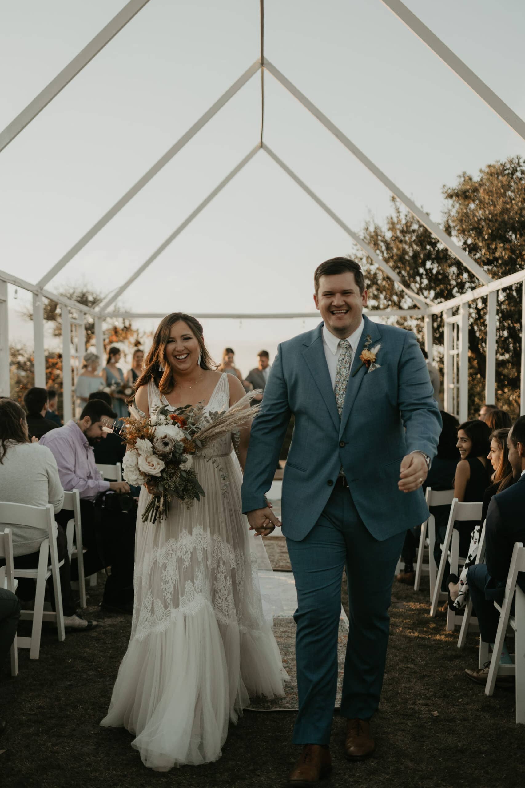 Bride and groom walking down the aisle after their wedding ceremony