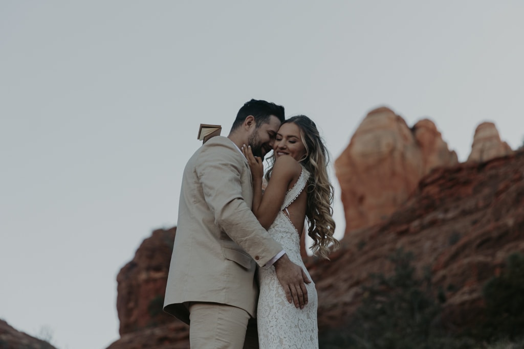 Bride and groom hugging each other immediately after their first kiss