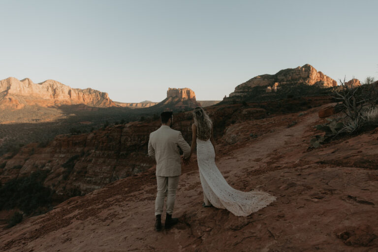 Couple watching alpenglow over desert mountains