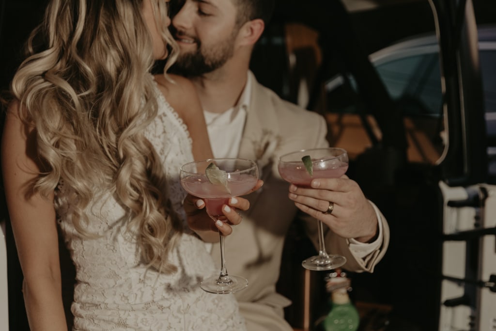 Couple clinking margarita glasses to celebrate their elopement