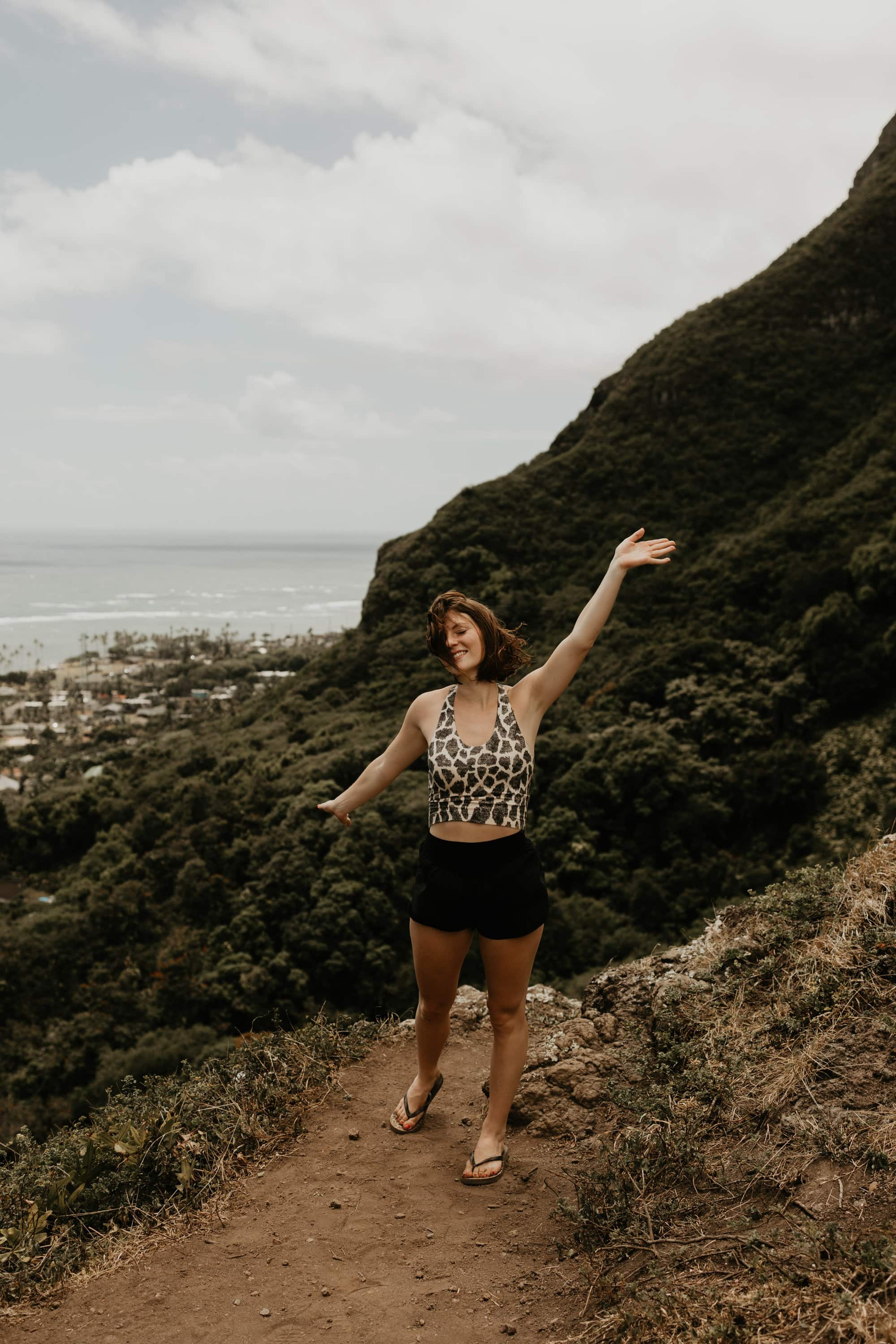 Hiking in Hawaii with lush mountain background