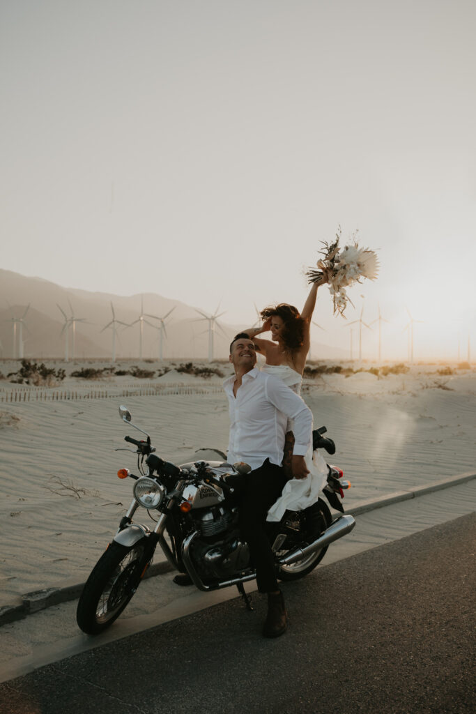 Couple riding off on a motorcycle from their wedding
