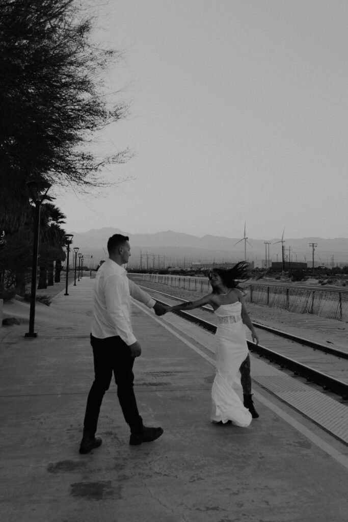 black and white photo of couple dancing in the wind
