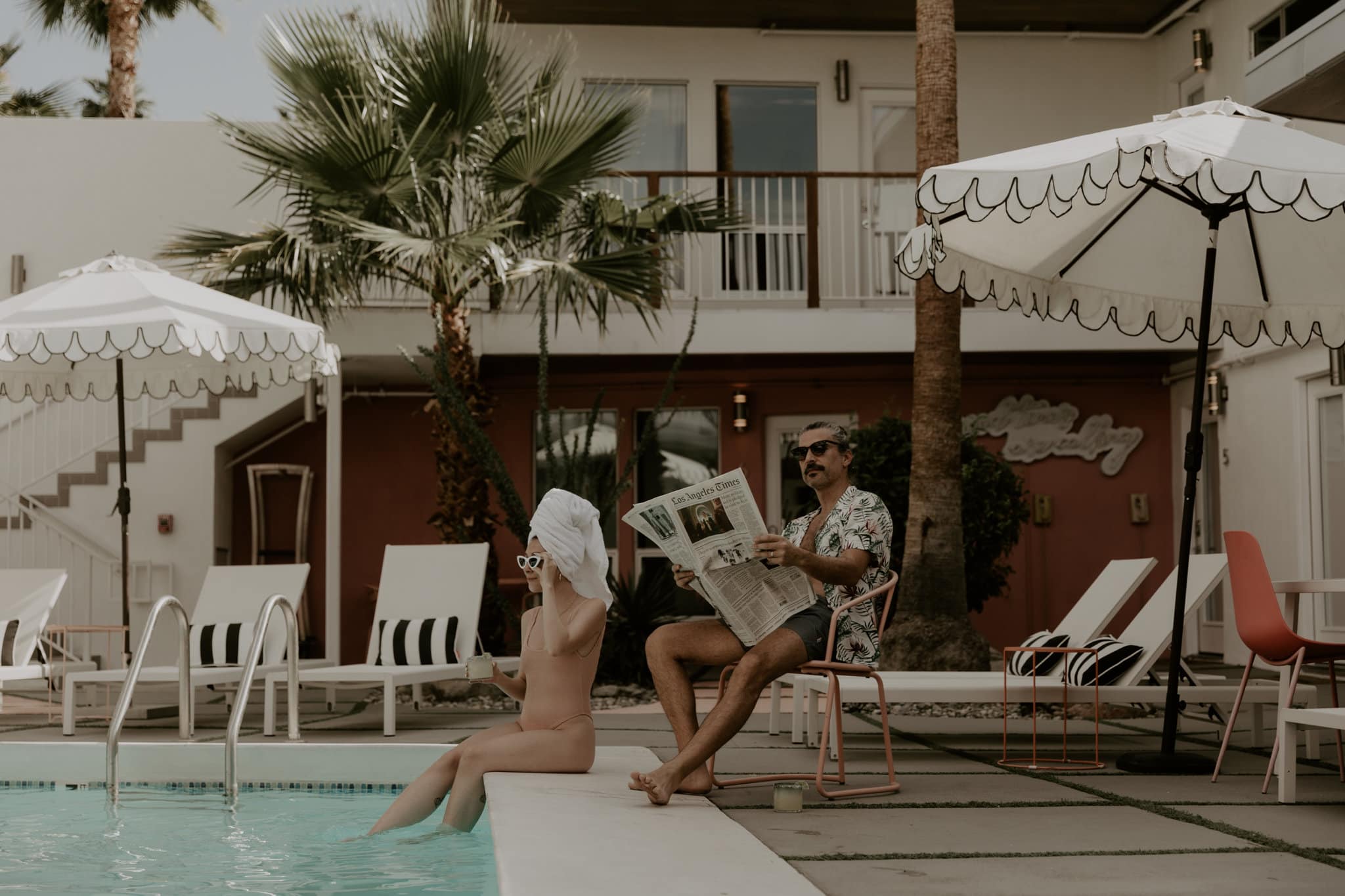 Couple enjoying a pool day with margaritas