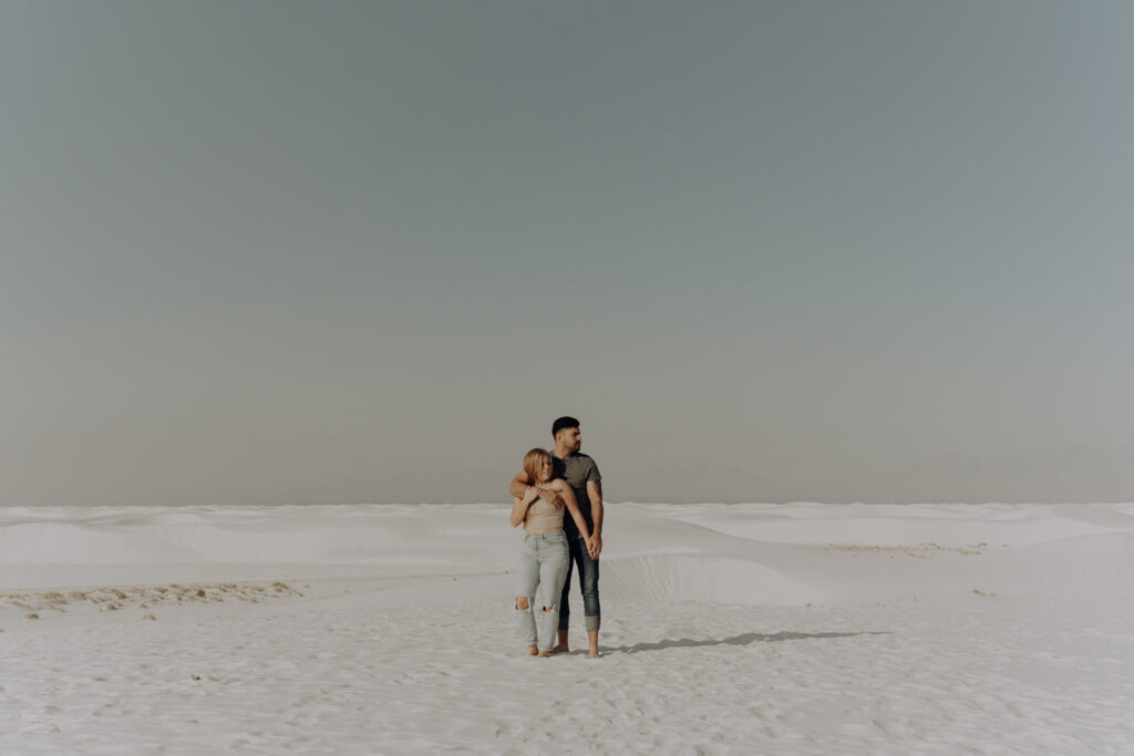 Wide shot of couple standing together in White Sand National Park