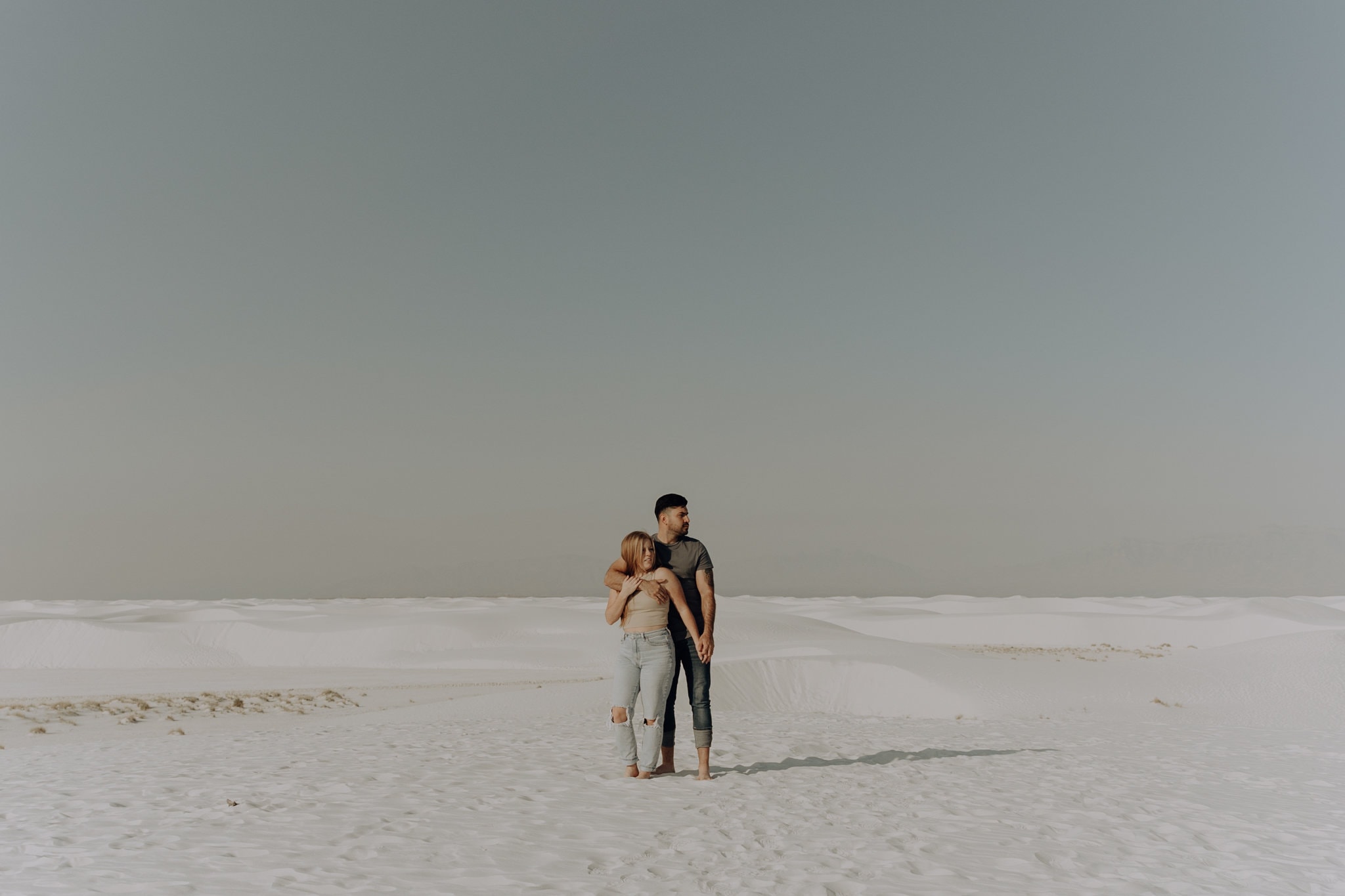 Wide shot of couple standing together in White Sand National Park